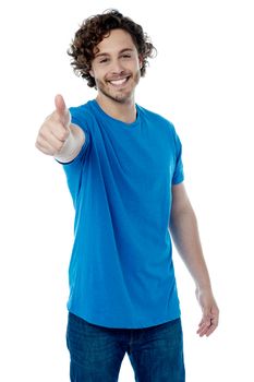 Casual young man showing thumb up gesture