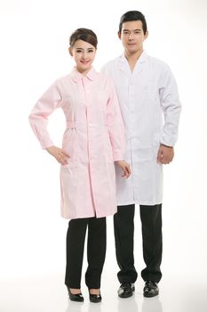 Staff wear coats in front of white background