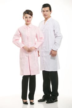Staff wear coats in front of white background