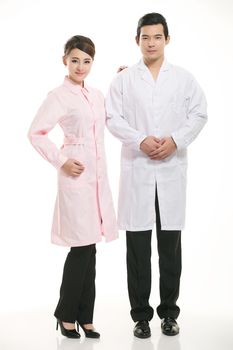 Staff wear coats in front of white background