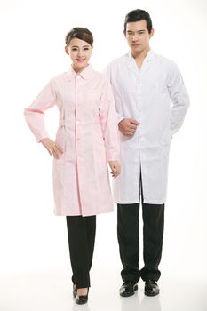 Staff wear coats in front of white background