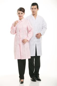 Staff wear coats in front of white background