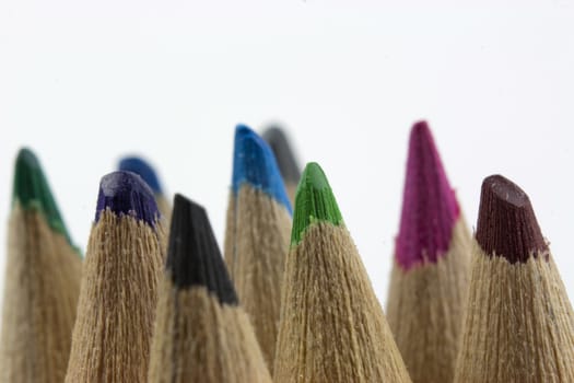 Close f of coloured pencils against a wooden background