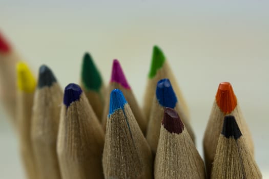 Close f of coloured pencils against a wooden background