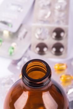 Close-up empty brown medical / pill bottle with top view, isolated on white background.