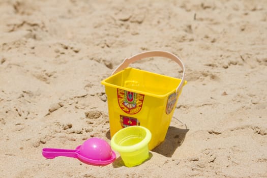 Children's colorful sandy toys on beautiful a beach. India Goa.