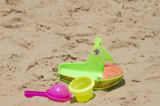 Children's colorful sandy toys on beautiful a beach. India Goa.