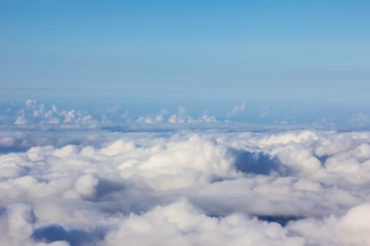 Soft clouds over view from airplane flying