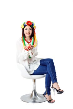 beautiful young brunette woman wearing national ukrainian clothes posing in studio on white background