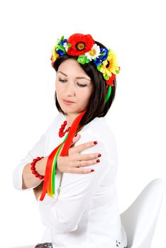 beautiful young brunette woman wearing national ukrainian clothes posing in studio on white background