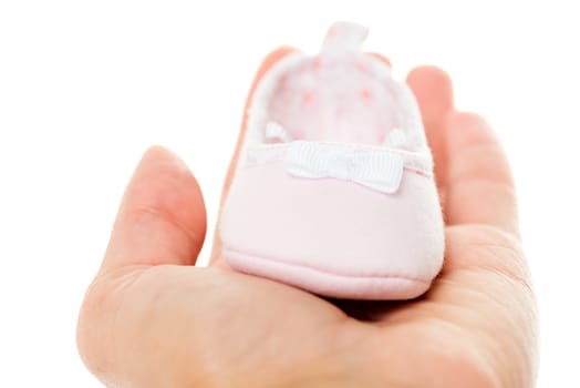 Close up pink baby shoes isolated on white background