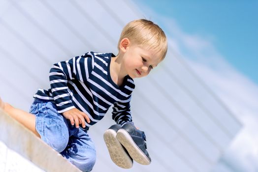 Portrait of little preschool boy outdoors.