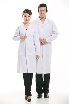 Staff wear coats in front of white background