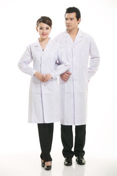 Staff wear coats in front of white background