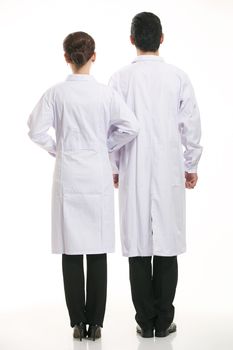 Staff wear coats in front of white background
