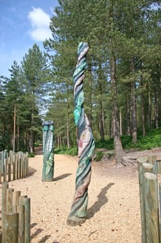 Two totem poles in the forest