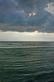 The ocean water with stormy clouds above
