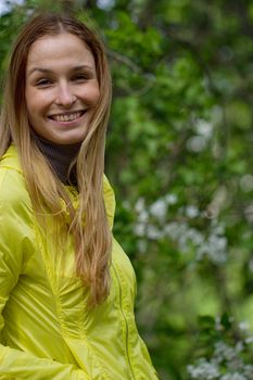 Portrait of beautiful smiling  girl against green park.