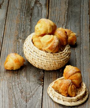 Stack of Croissant Cookies with Jam in Wicker Bowls closeup on Wooden background