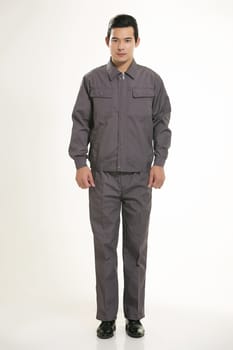 The young engineer various occupation clothing standing in front of a white background