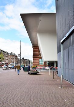 Amsterdam, Netherlands - May 6, 2015: People visit famous Stedelijk Musem in Amsterdam located in the museum park, Netherlands on May 6, 2015