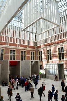 Amsterdam, Netherlands - May 6, 2015: Tourist at the Main hall of the Rijksmuseum in Amsterdam on May 6, 2015. The original interior courtyards have been redesigned to create the imposing new entrance space of the Atrium