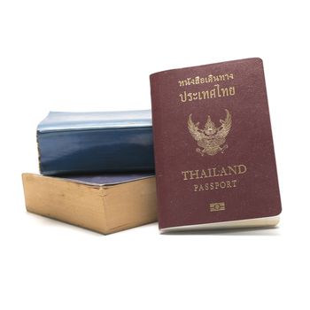 stack of book and passport isolated on white background