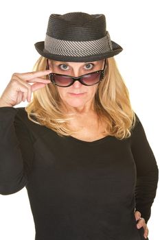 Cute woman in black with hat looking over sunglasses