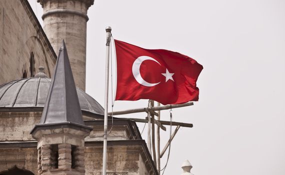 National flag of Turkey flying on mosque building exterior