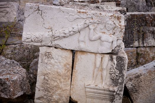Stones with carved figure of youth at Antioch Pisidian in Turkey