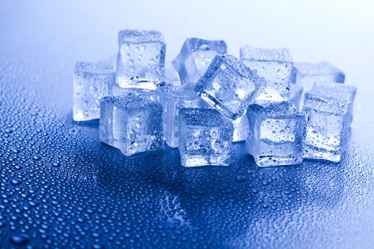 Ice cubes on blue background