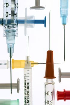 Medical syringes and needles - used for giving injections of drugs in the treatment of illness and disease.