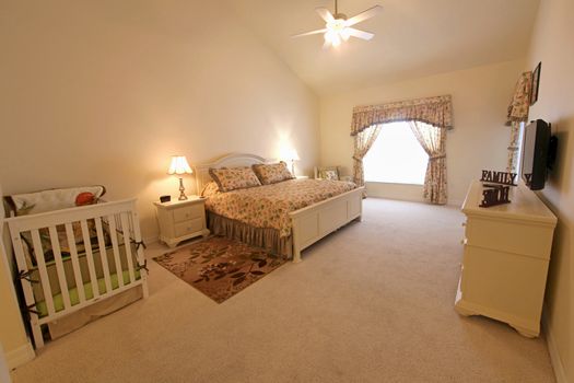 An interior shot of a master bedroom