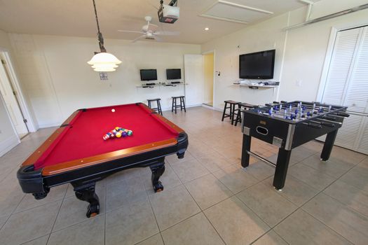 A games room with pool table and foosball