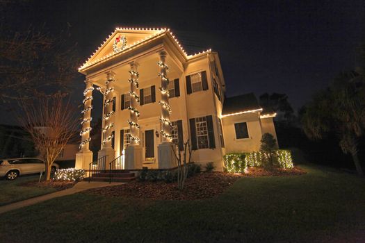 A Colonial House with a lot of Christmas Lights