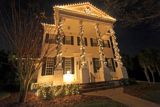 A Colonial House with a lot of Christmas Lights