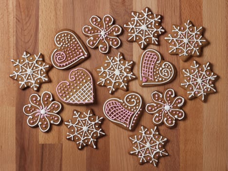 Decorated Christmas gingerbread cookies on wooden background