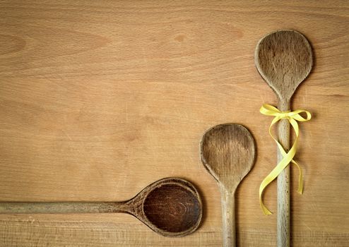 background three spoons with yellow ribbon bow