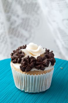 Close up of a decadent gourmet cupcake with chocolate and vanilla frosting. 