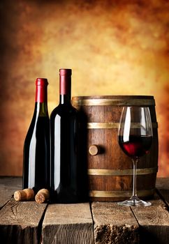 Bottles and cask of wine on a wooden table