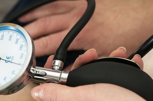 Female Doctor uses a sphygmomanometer