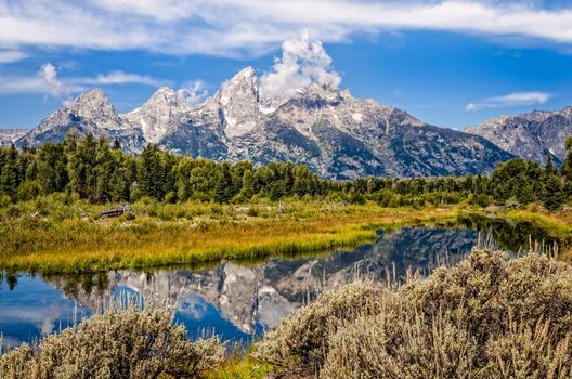 Scenic view of Grand Teton mountains  with water reflection, Wyoming, USA