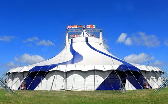 Circus tent in a field on a summer day.