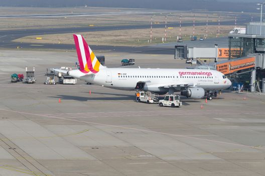 Dusseldorf, Nrw, Germany - March 18, 2015: German Wings Airbus A319 landing at the Dusseldorf airport. Terminal boarding passengers.