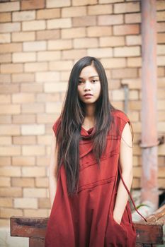 beautiful girl is posing with red suit.