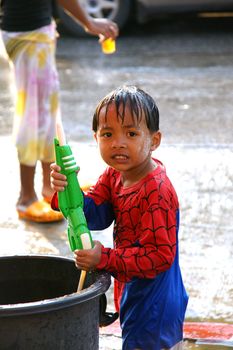 CHIANGMAI,THAILAND-APRIL 14, 2011: The boy with water pressure gun in a water fight festival or Songkran Festival (Thai New Year), on April 14, 2011 in Chiangmai, Thailand.