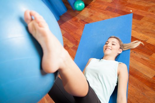 Woman stretching with a ball