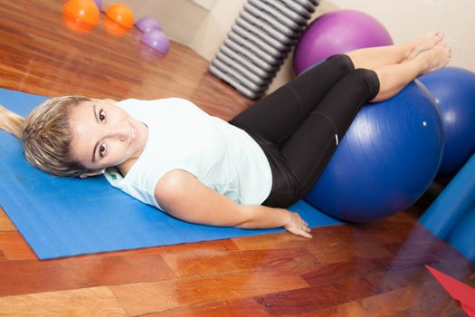 Woman stretching with a ball