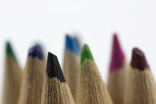 Close f of coloured pencils against a wooden background