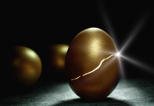 Light sparkling from inside a hatching gold nest egg, a metaphor for success and investments such as retirement and savings 